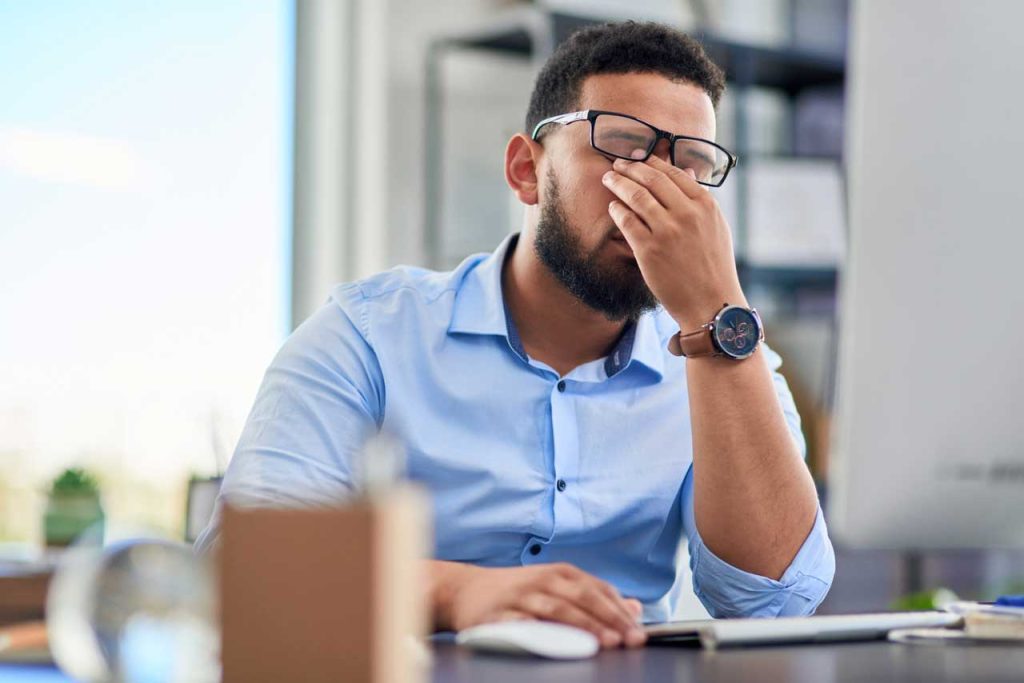 Person experiencing daytime sleepiness at work